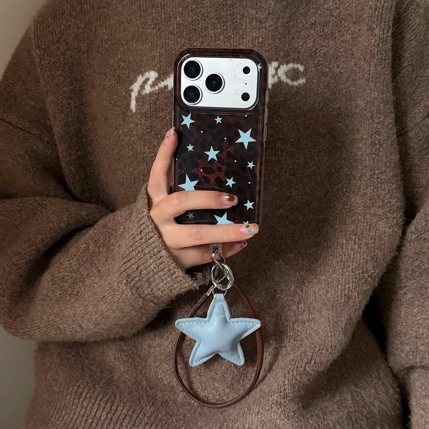 Dark Brown Leopard Print iPhone Case with Blue Star Accents, Reflective Tin Foil Texture