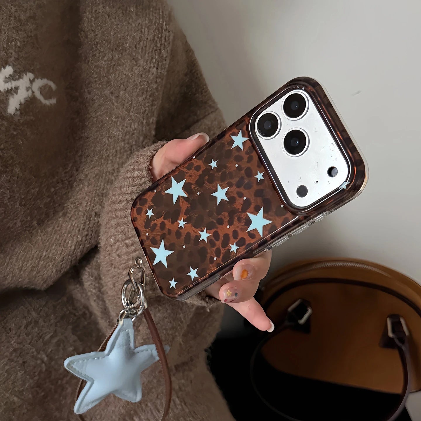 Dark Brown Leopard Print iPhone Case with Blue Star Accents, Reflective Tin Foil Texture